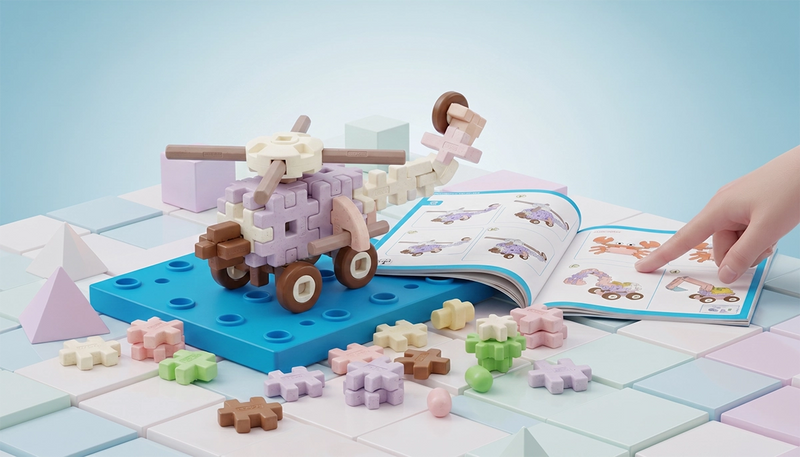 Children's building block set with a toy horse and carriage on a colorful surface, accompanied by an open book.