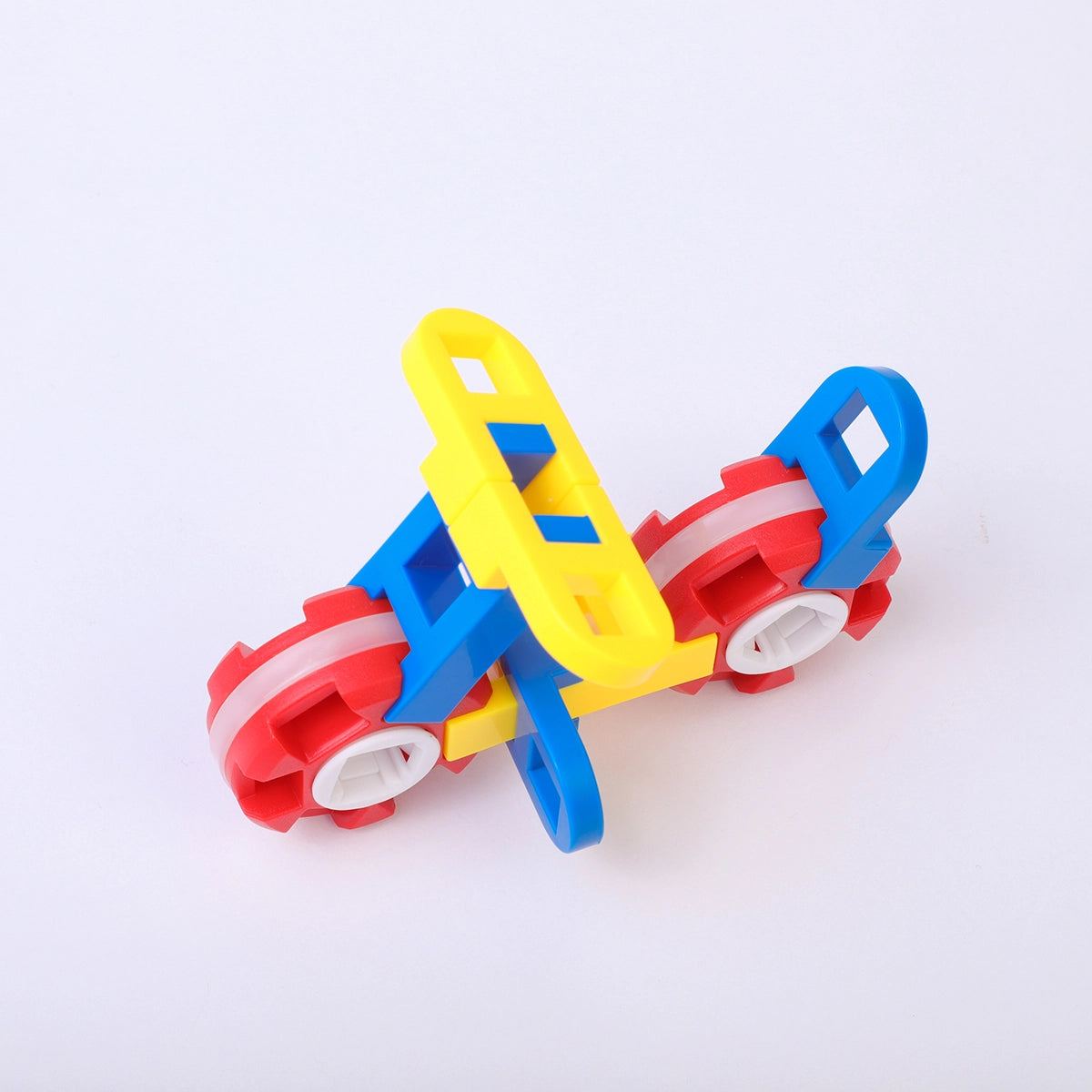 A motorized sports car pack with red moving wheels engineered from PINOER STEM blocks.
