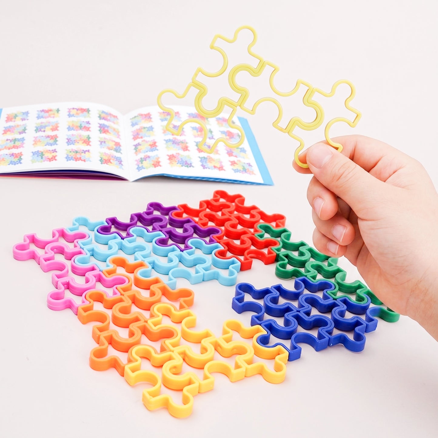 Close-up of the smooth wavy interlocking joints on PINOER multi-color geometric logic tracks.