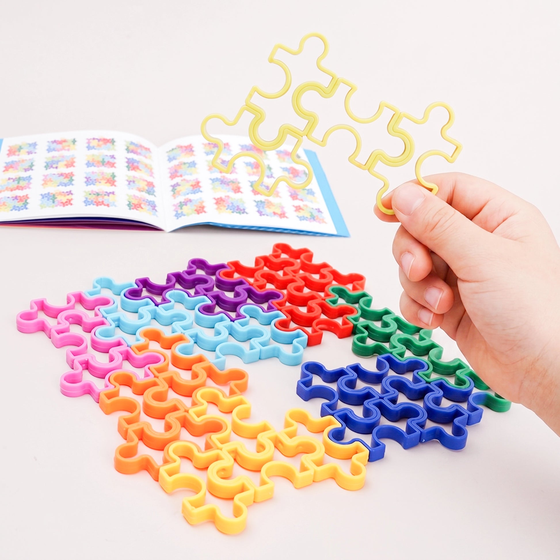Close-up of the smooth wavy interlocking joints on PINOER multi-color geometric logic tracks.