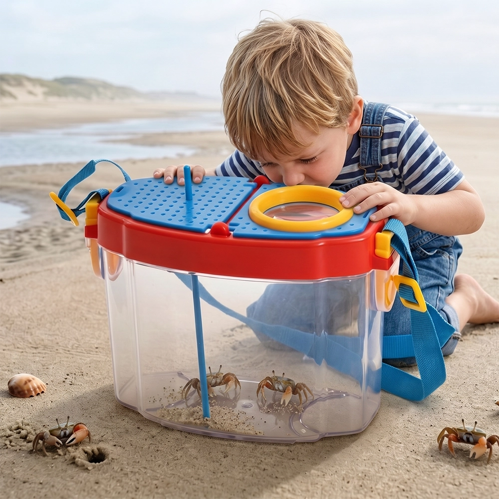A 4-year-old toddler using bug catcher scissors to capture a butterfly in the park.